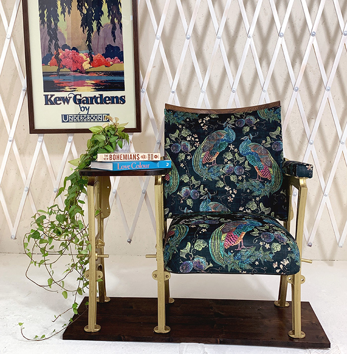 Single with a side table upholstered in Peacocks by Art of the Loom