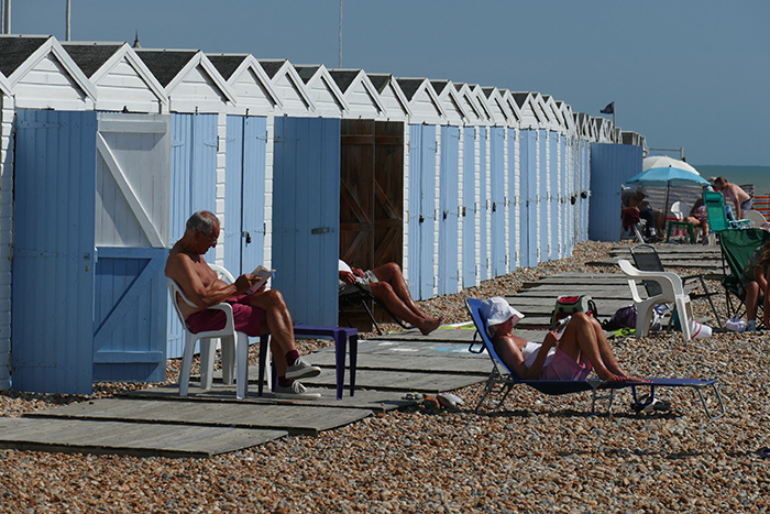 A line of blue beach huts on the seafront © Norman Miller